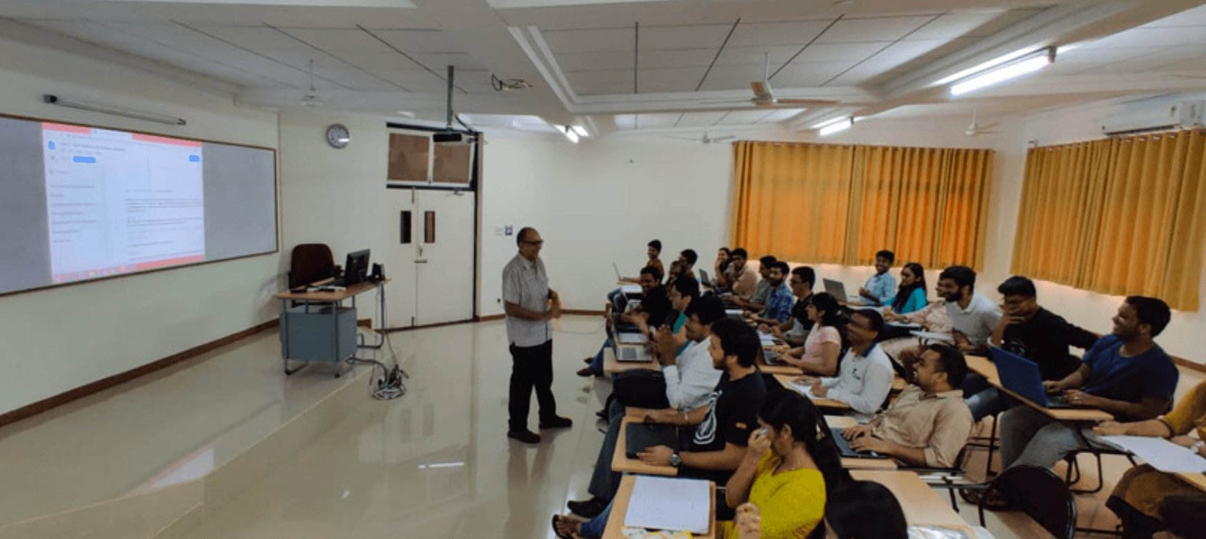 Ravi Visvanathan teaching his students in a classroom. 
