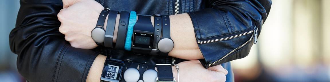 Rachel Kalmar's arms decked out in multiple wearable devices up each wrist and forearm