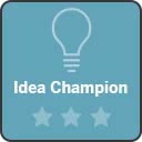 A teal-colored Tableau Community badge with a line drawing of a light bulb, text ‘Idea Champion, and three stars.