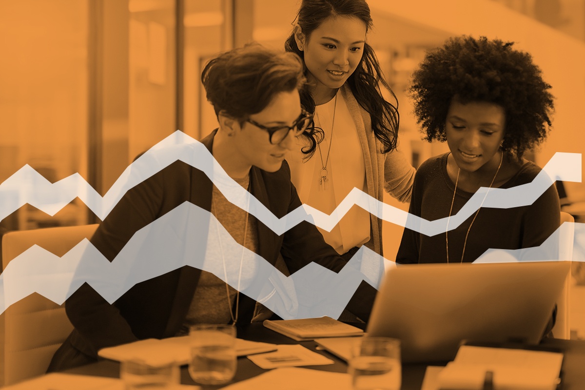 Three diverse women collaborating with data on a laptop, surrounded by white viz art like an area chart as if their data is coming to life around them.