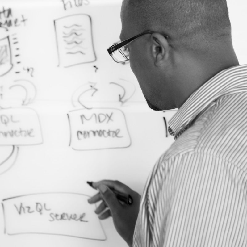 Man reviewing data on whiteboard