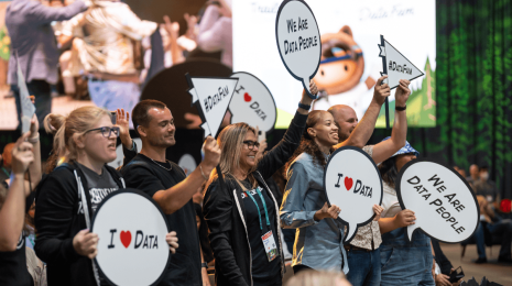 Tableau Community holding data signs at Dreamforce during the Tableau keynote
