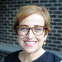 Headshot of former Tableau CMO Elissa Fink wearing glasses and smiling at camera